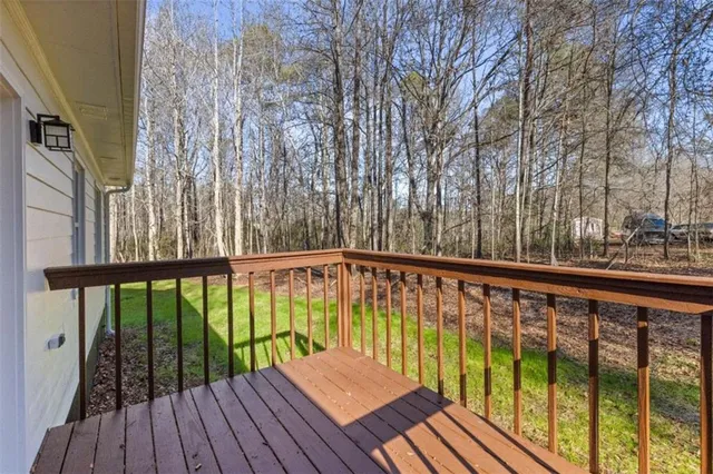 a view of balcony with wooden floor and fence