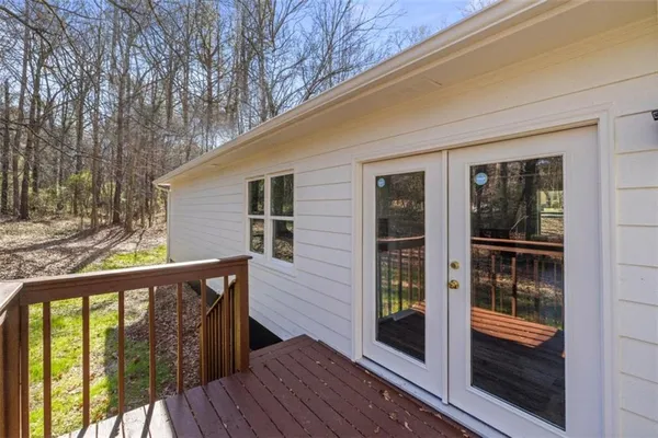 a view of balcony with floor to ceiling window and wooden floor