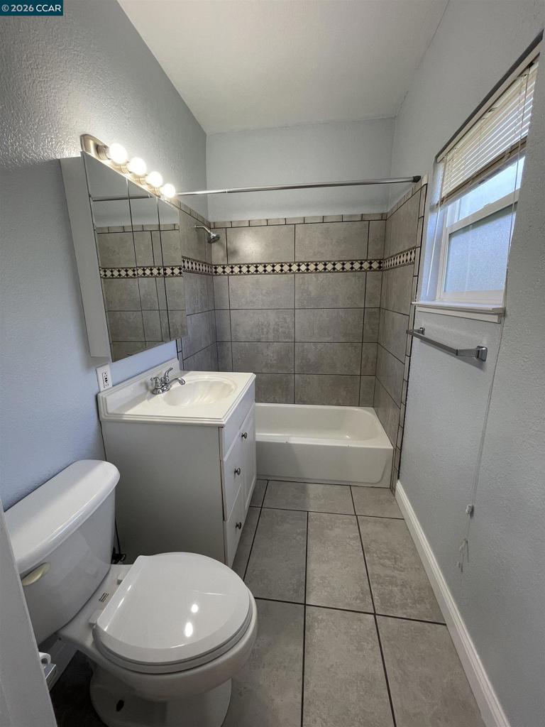 1705 Linden Street Oakland, CA 94607 - Photo 17 of 22 a bathroom with a sink a toilet and shower