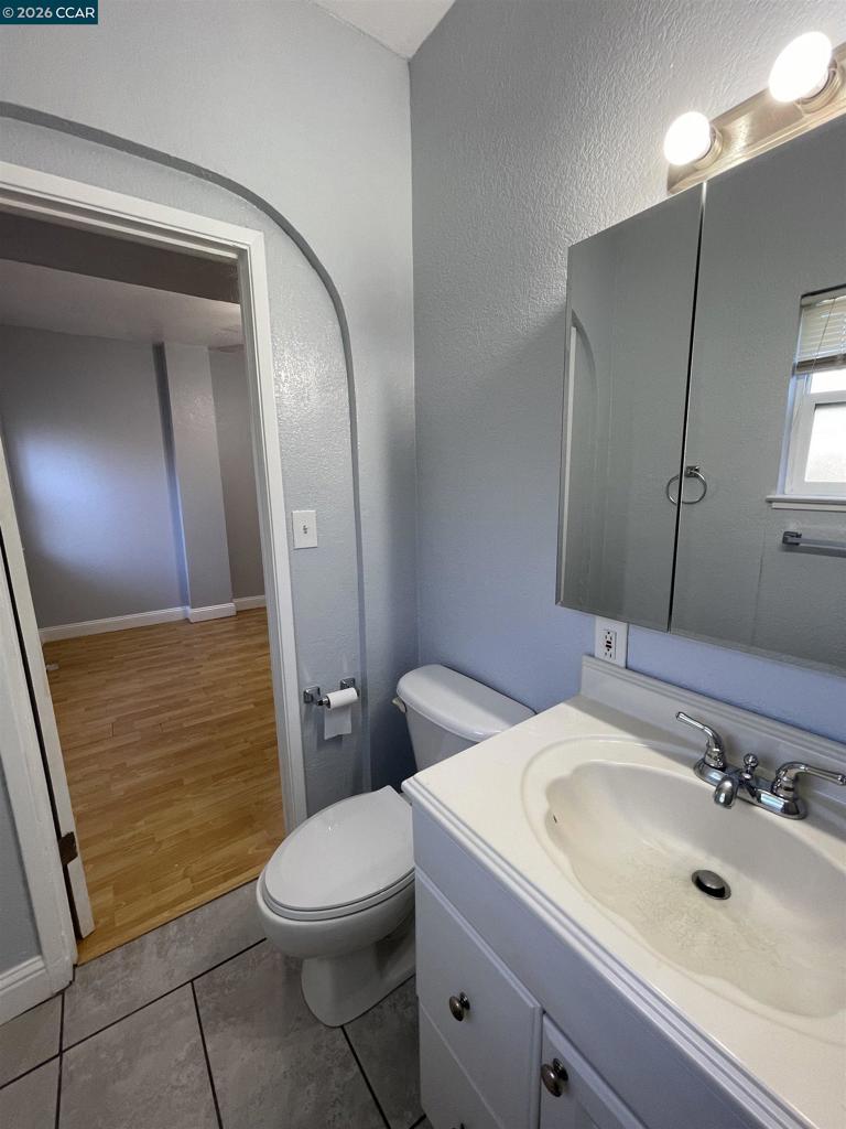 1705 Linden Street Oakland, CA 94607 - Photo 20 of 22 a bathroom with a sink a toilet and mirror
