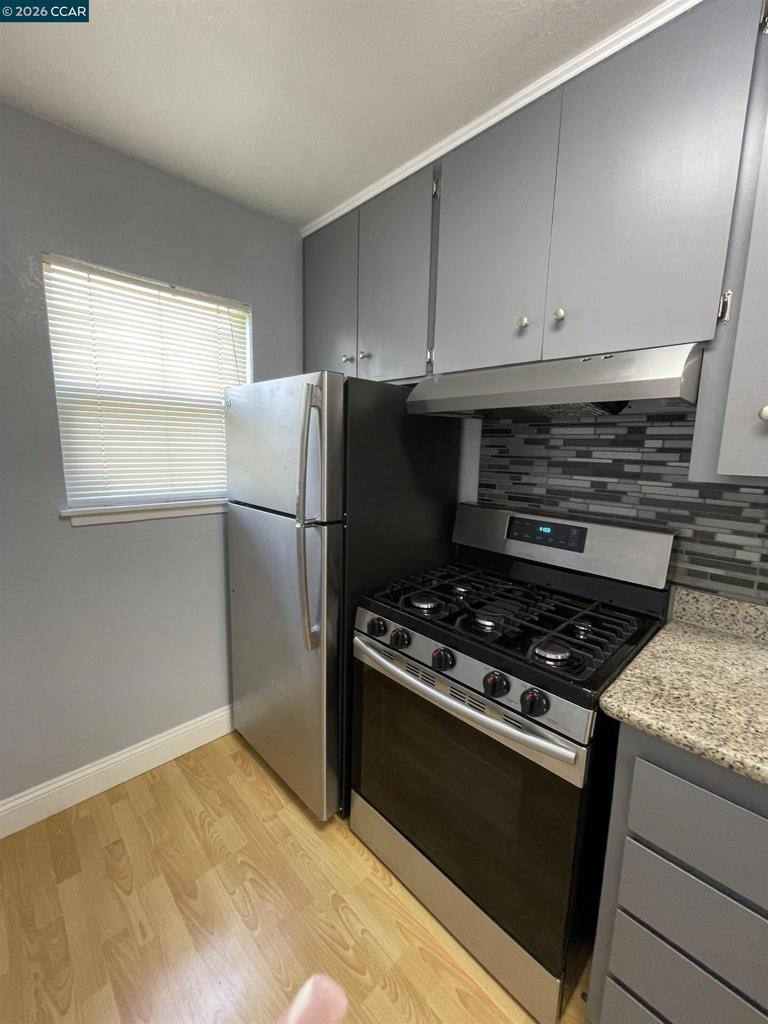 1705 Linden Street Oakland, CA 94607 - Photo 2 of 22 a kitchen with white cabinets and a stove top oven