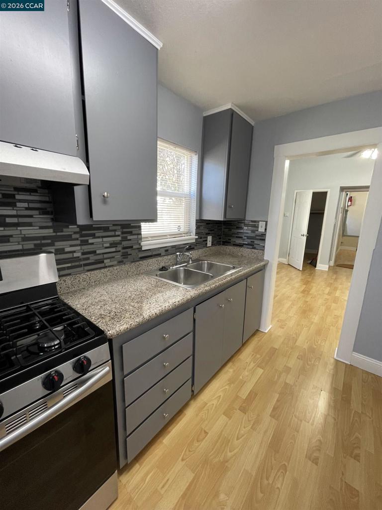 1705 Linden Street Oakland, CA 94607 - Photo 4 of 22 a kitchen with granite countertop a stove and a sink