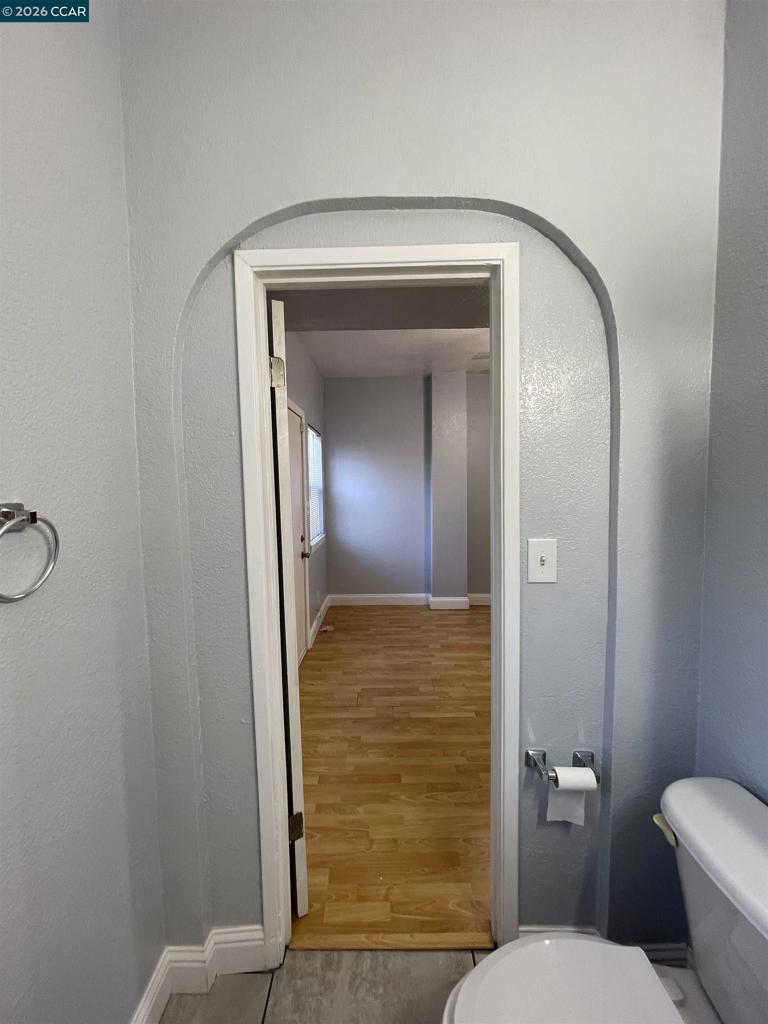 1705 Linden Street Oakland, CA 94607 - Photo 8 of 22 a bathroom with a toilet and a mirror