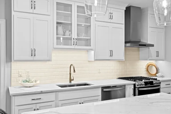 a kitchen with kitchen island a sink stove and refrigerator