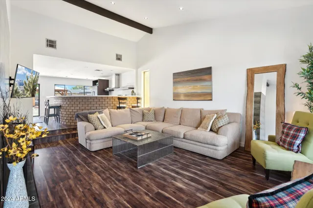 a living room with furniture wooden floor and a fireplace