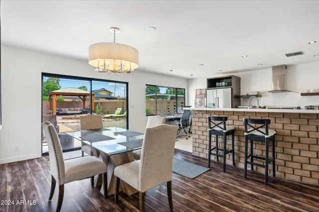 a dining room with furniture and a floor to ceiling window