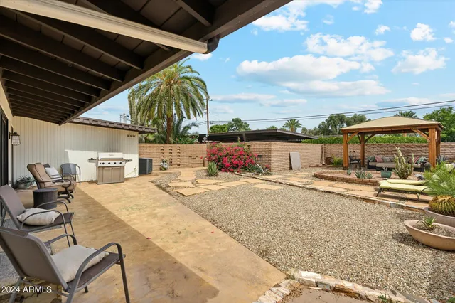 a view of a patio with table and chairs and potted plants