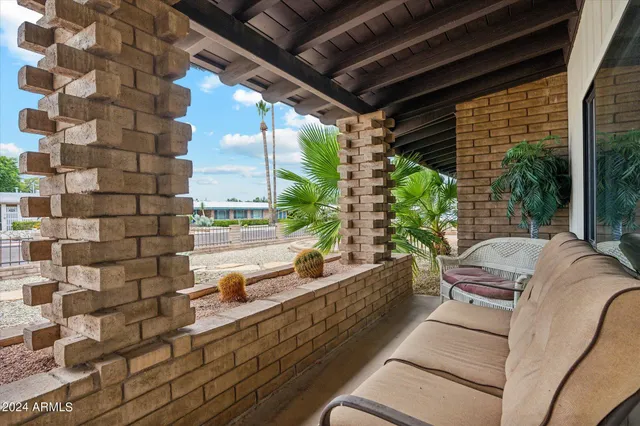 a balcony with furniture and a potted plant