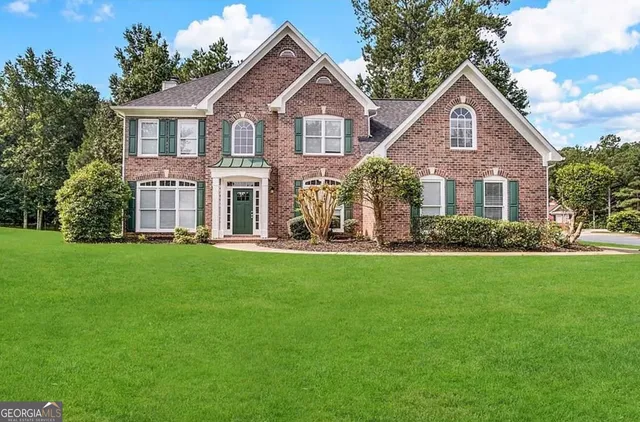 a front view of a house with a yard