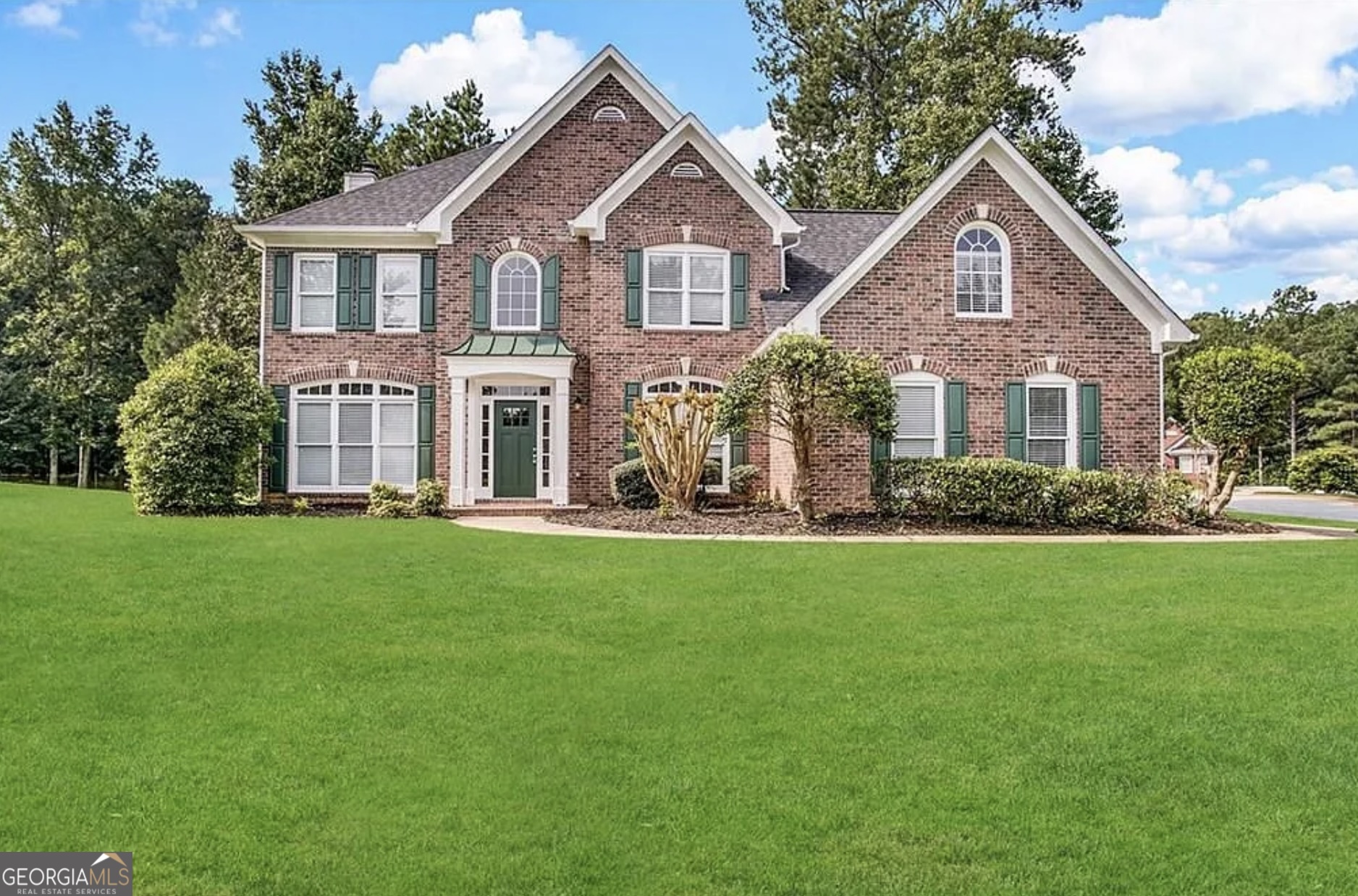 a front view of a house with a yard
