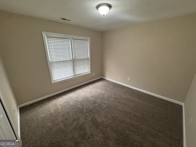 an empty room with a empty space and windows