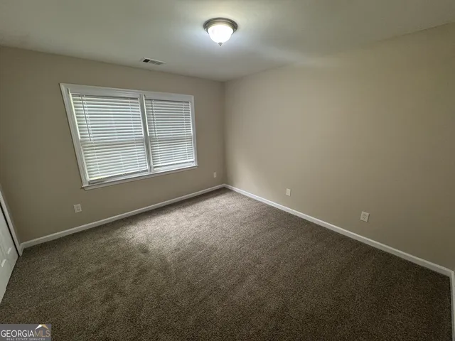 an empty room with a empty space and windows