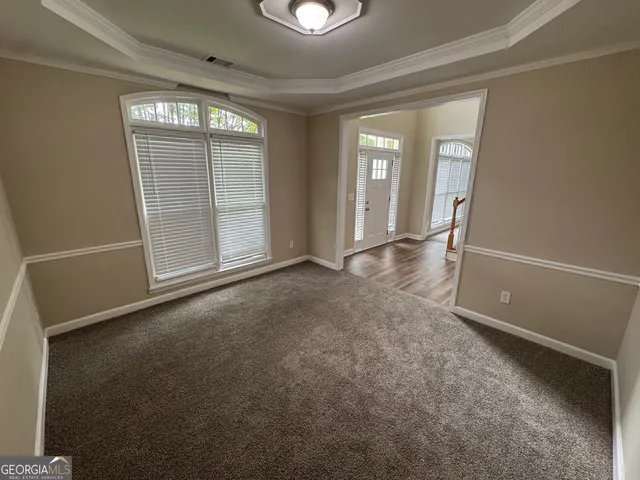 an empty room with windows and entrance