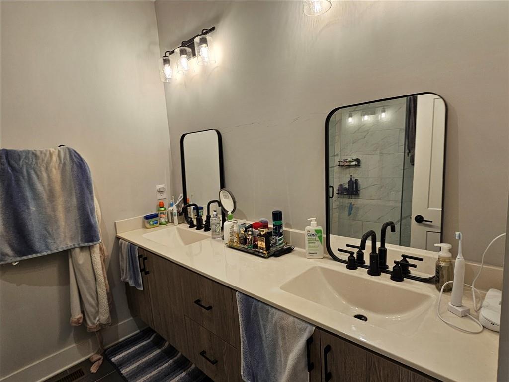 732 Perch Place Atlanta, GA 30312 - Photo 12 of 25 a bathroom with a double vanity sink and a mirror
