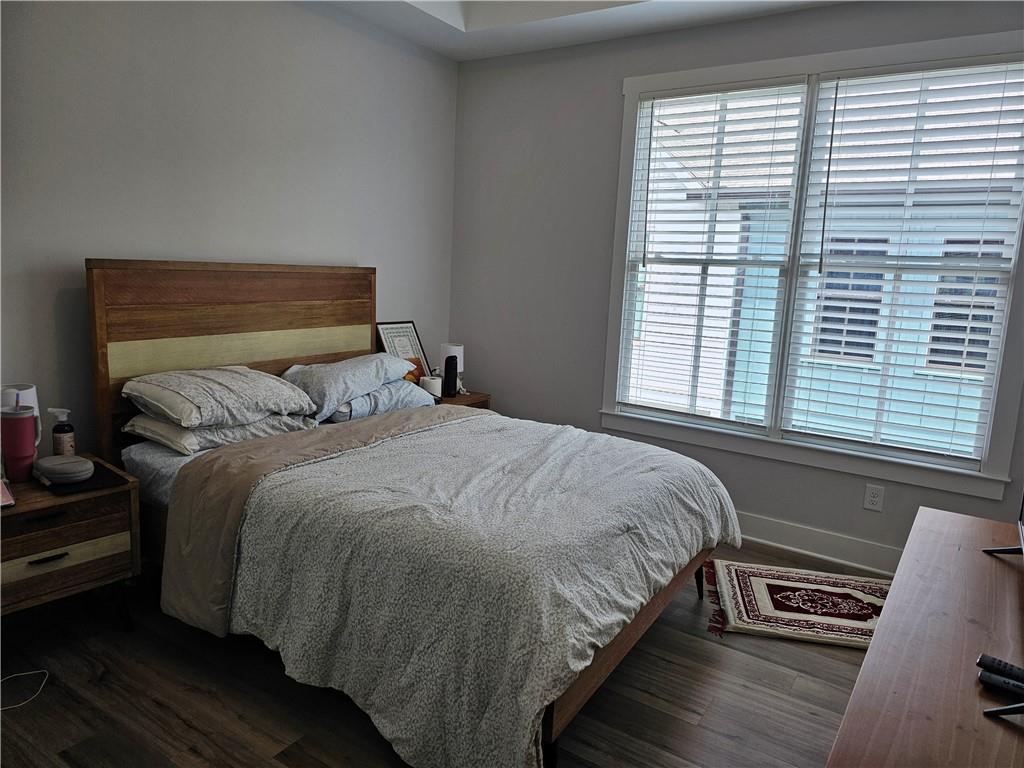 732 Perch Place Atlanta, GA 30312 - Photo 16 of 25 a bedroom with a bed and wooden floor