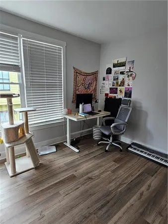 a view of a workspace with furniture and a window