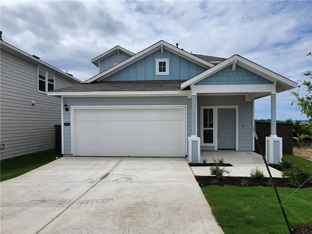 a front view of a house with yard