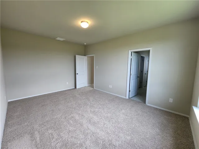 an empty room with a empty space and windows