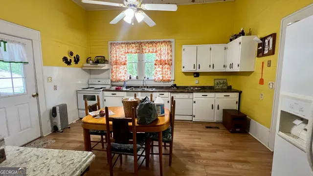 a dining room with furniture and wooden floor