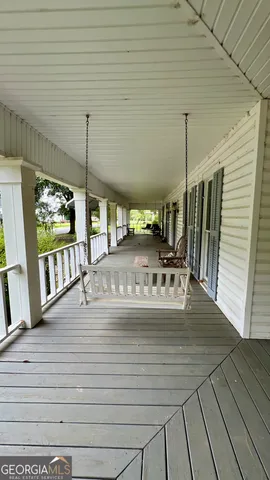 a view of a living room with furniture floor to ceiling window and floor