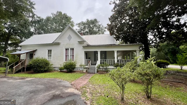 a backyard of a house with a table and chairs