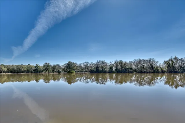 a view of a lake with houses in the background
