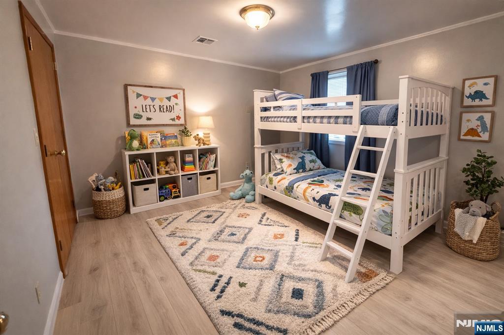47 Harding Court, Unit 2 Garfield, NJ 07026 - Photo 12 of 34 a bed room with a bed and a book shelf
