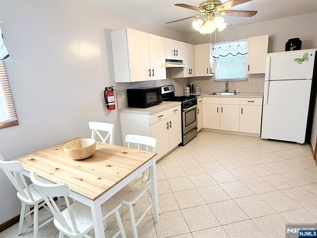 47 Harding Court, Unit 2 Garfield, NJ 07026 - Photo 2 of 34 a kitchen with a white cabinets and white appliances
