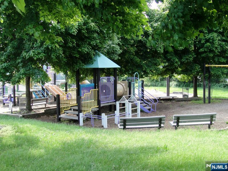47 Harding Court, Unit 2 Garfield, NJ 07026 - Photo 24 of 34 a view of a swimming pool with lawn chairs under an umbrella