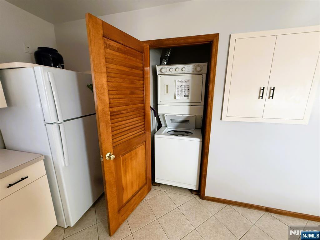 47 Harding Court, Unit 2 Garfield, NJ 07026 - Photo 6 of 34 a utility room with fridge and wooden floor
