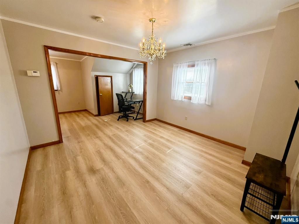 47 Harding Court, Unit 2 Garfield, NJ 07026 - Photo 7 of 34 wooden floor in an empty room with a window