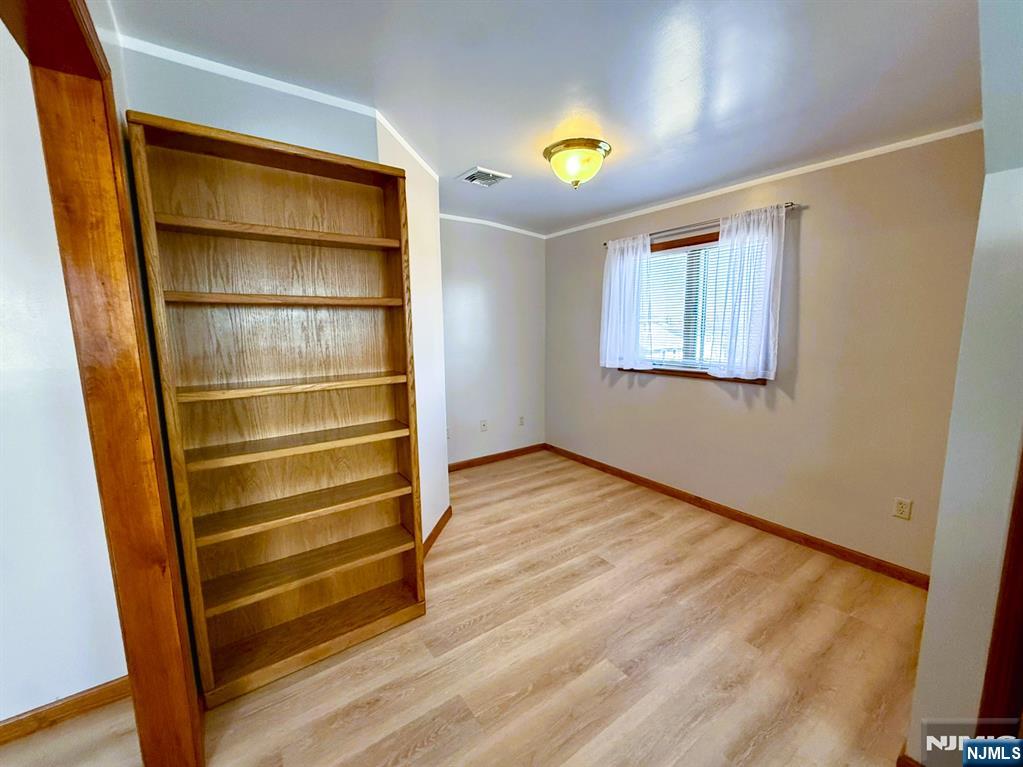 47 Harding Court, Unit 2 Garfield, NJ 07026 - Photo 8 of 34 a view of room with wooden floor and window