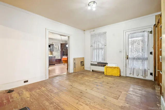 a view of a livingroom with wooden floor and a flat screen tv