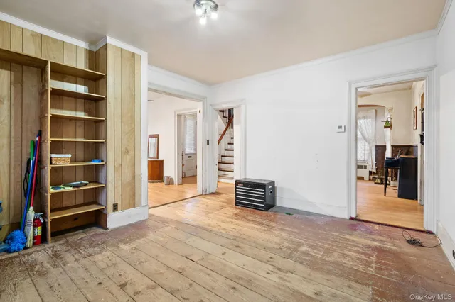 a view of a kitchen with white cabinets and a wooden floor