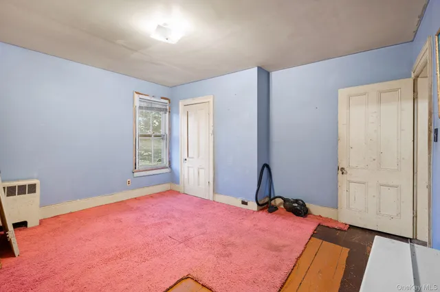 a view of a room with wooden floor and cabinet