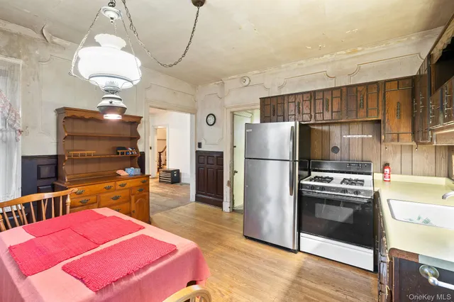 a kitchen with refrigerator and cabinets