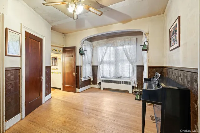 a view of a hallway with workspace and a window