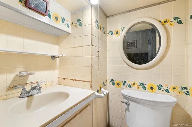 a living room with a couch and a dresser with wooden floor