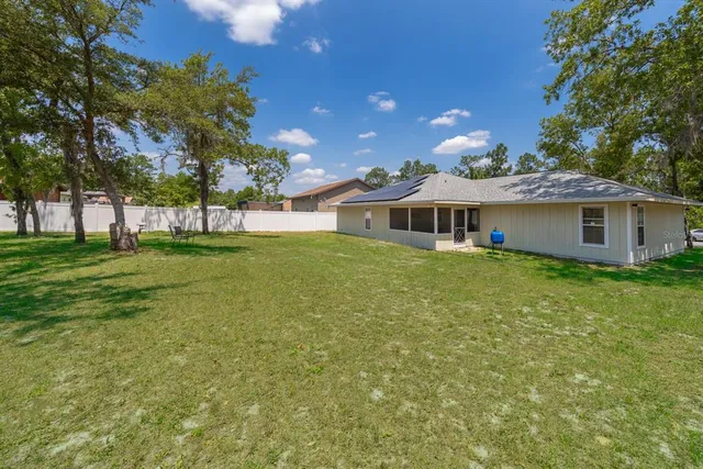 a view of a house with a backyard