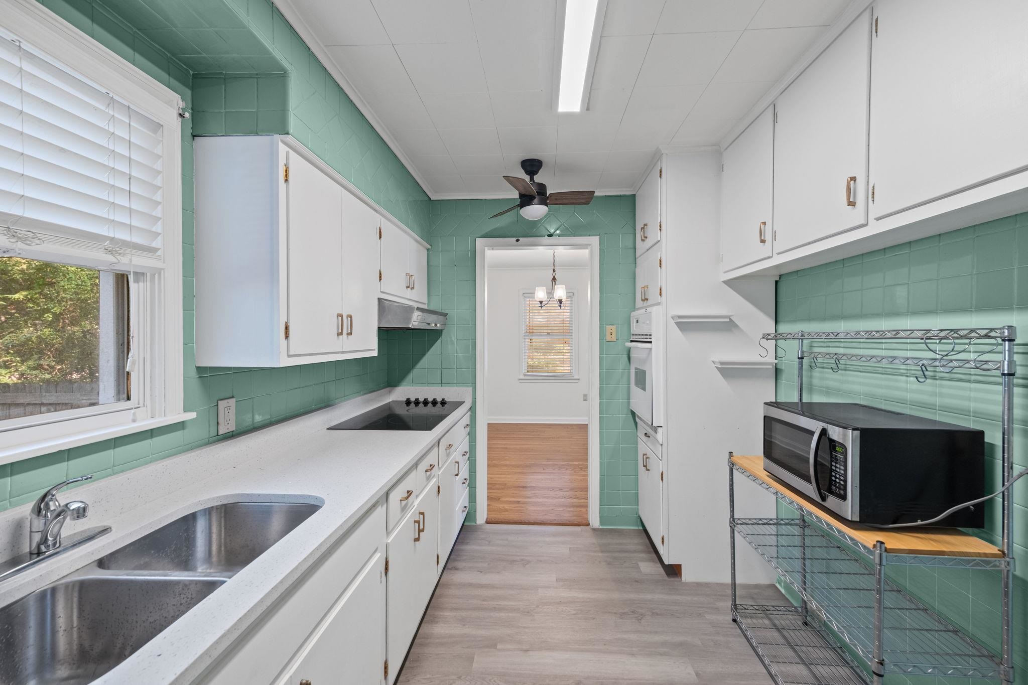 1261 Marcia Road Memphis, TN 38117 - Photo 11 of 27 a kitchen with stainless steel appliances granite countertop a sink and a stove top oven