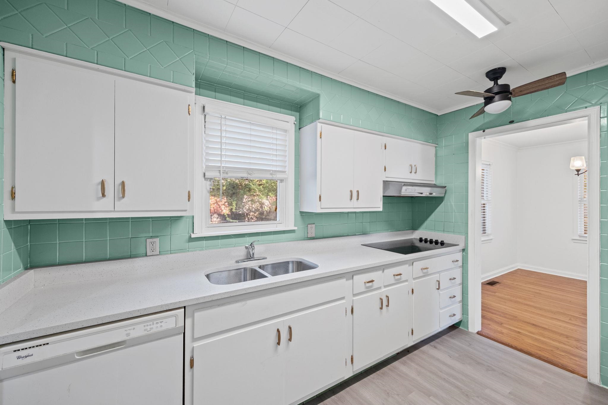 1261 Marcia Road Memphis, TN 38117 - Photo 12 of 27 a kitchen with white cabinets and white appliances