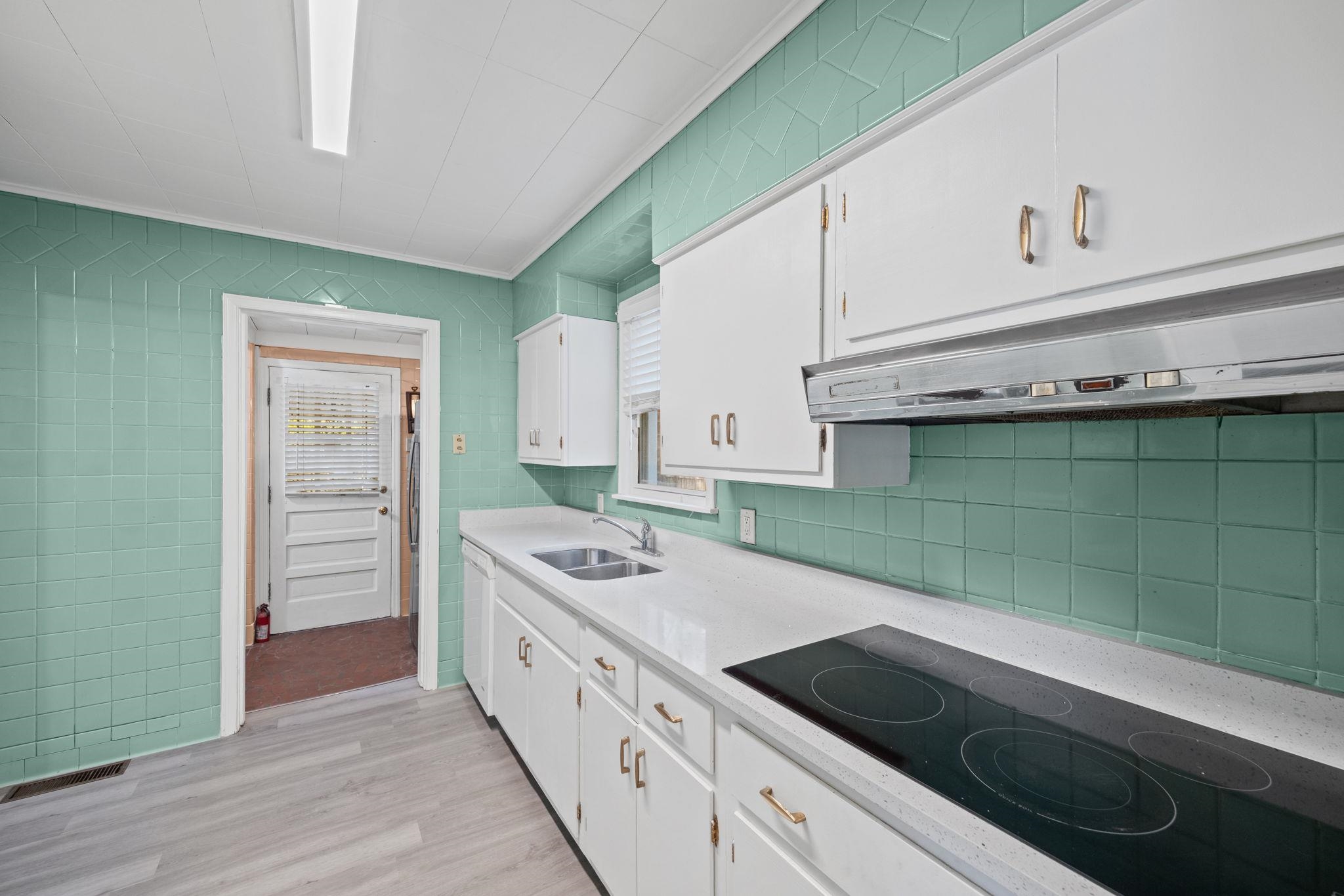 1261 Marcia Road Memphis, TN 38117 - Photo 14 of 27 a kitchen with a cabinets and a stove top oven
