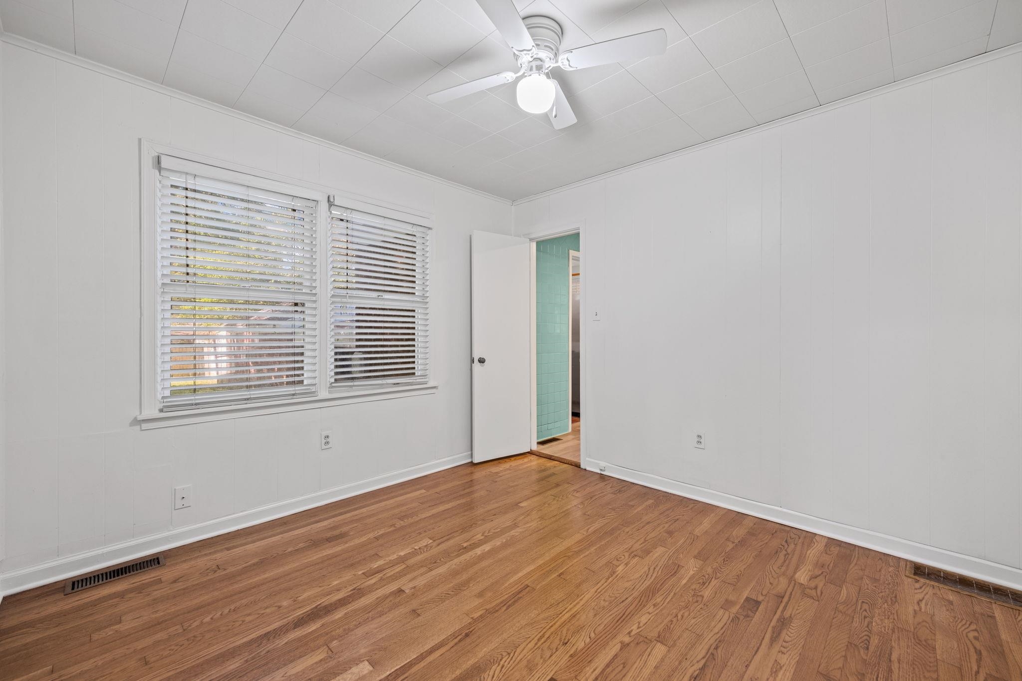 1261 Marcia Road Memphis, TN 38117 - Photo 21 of 27 a view of empty room with wooden floor and fan
