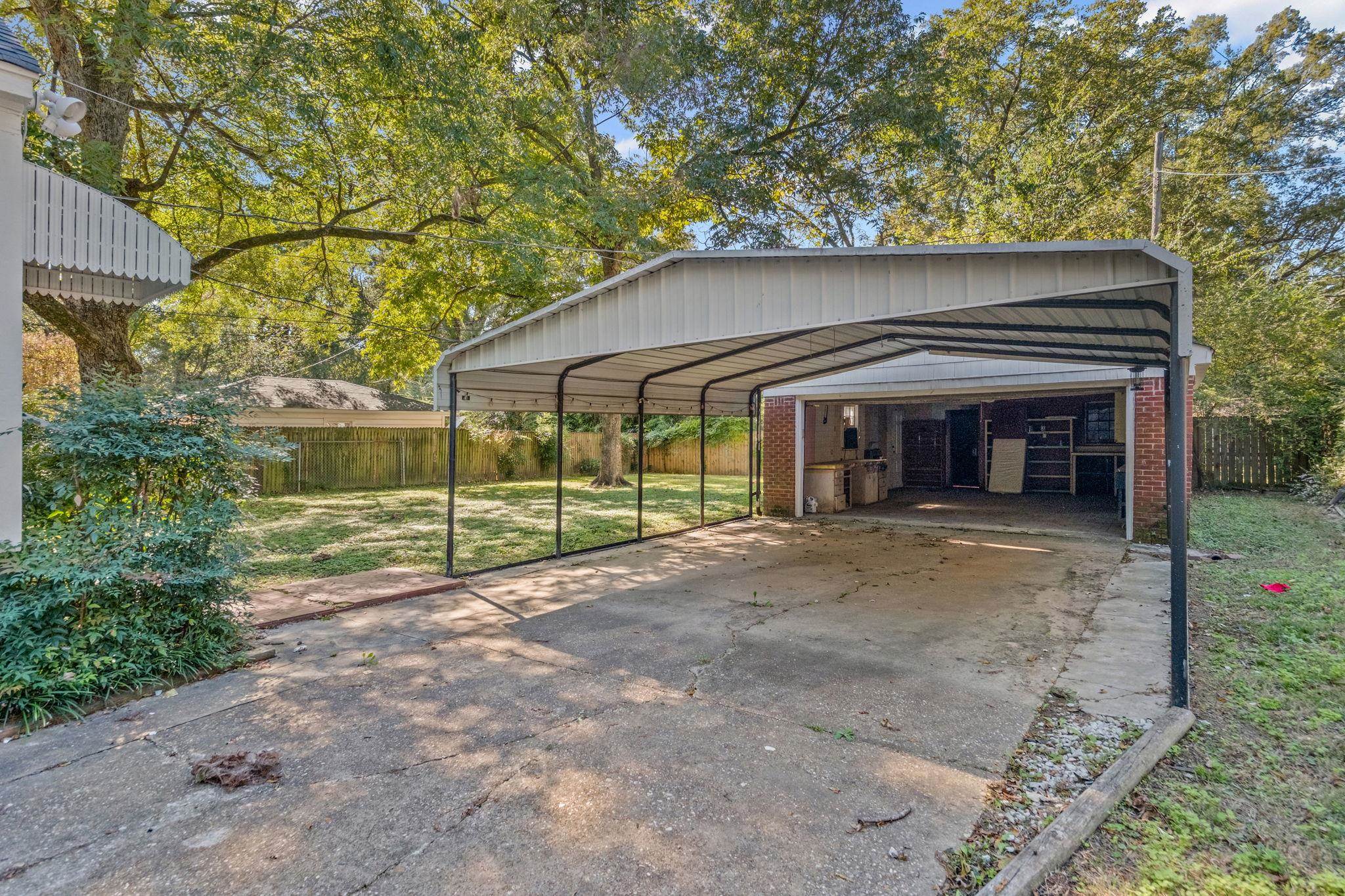 1261 Marcia Road Memphis, TN 38117 - Photo 27 of 27 a view of a house with a small yard and a large tree