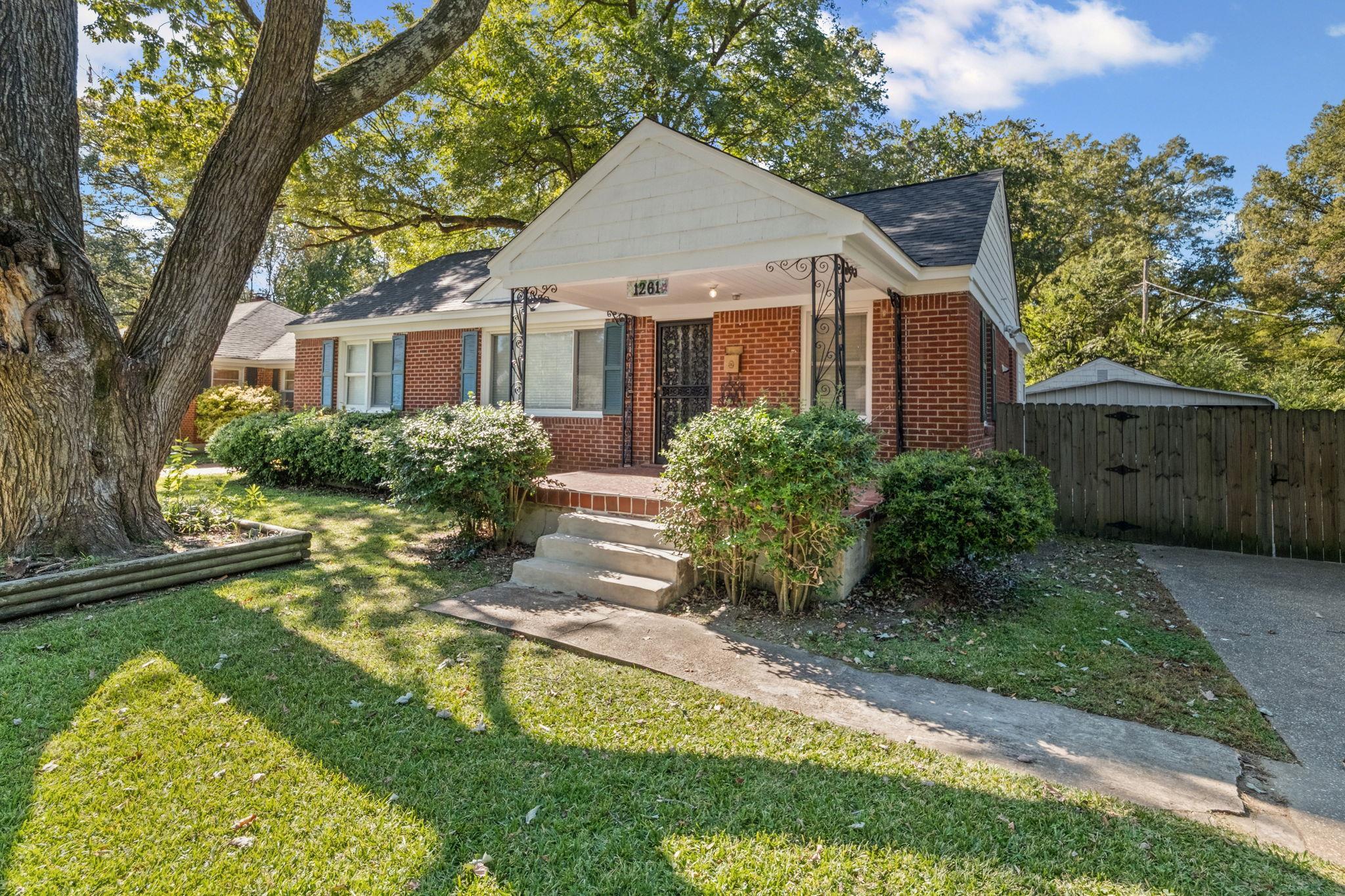 1261 Marcia Road Memphis, TN 38117 - Photo 3 of 27 a front view of a house with a yard