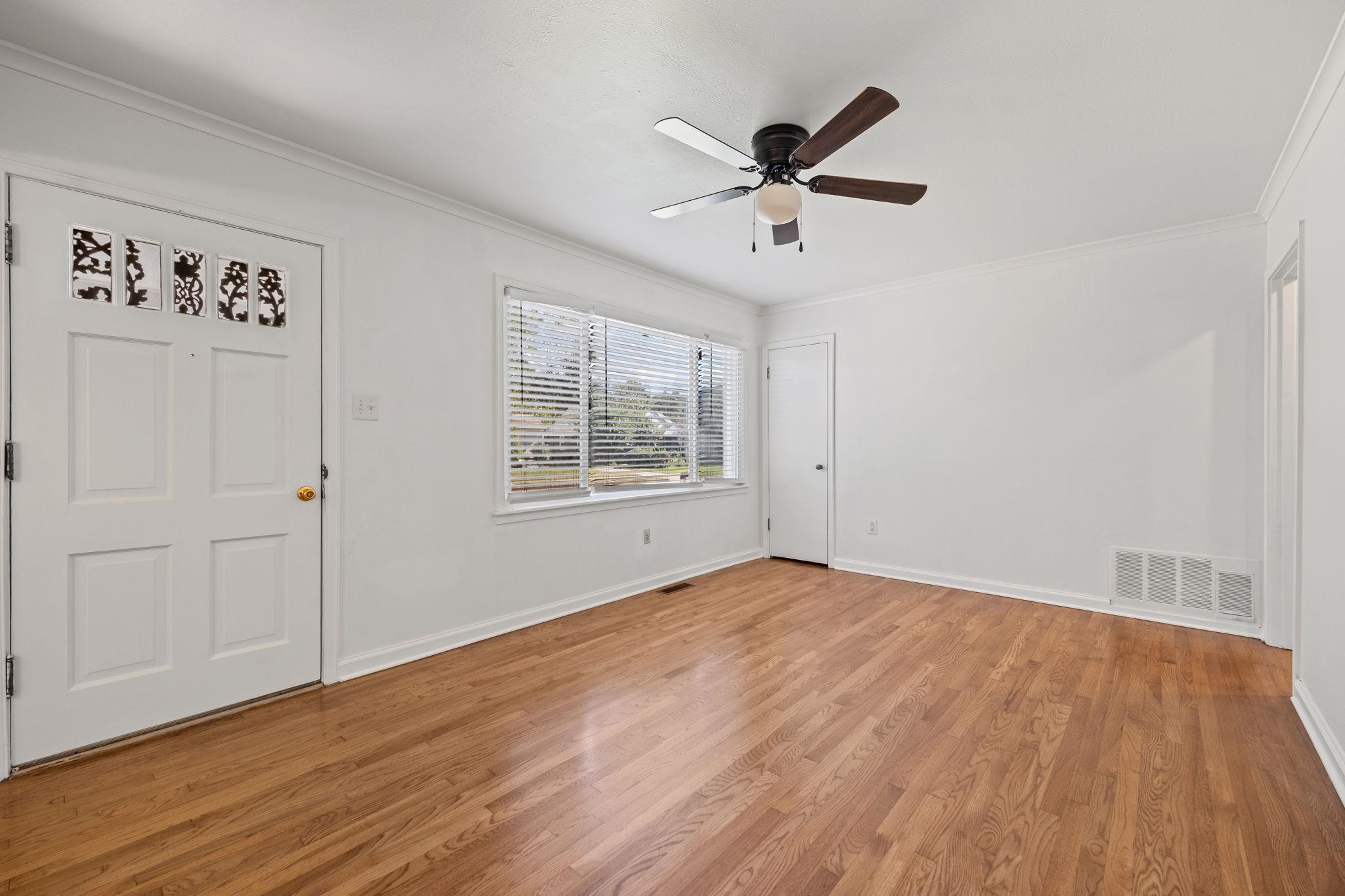 1261 Marcia Road Memphis, TN 38117 - Photo 5 of 27 a view of empty room with wooden floor and fan