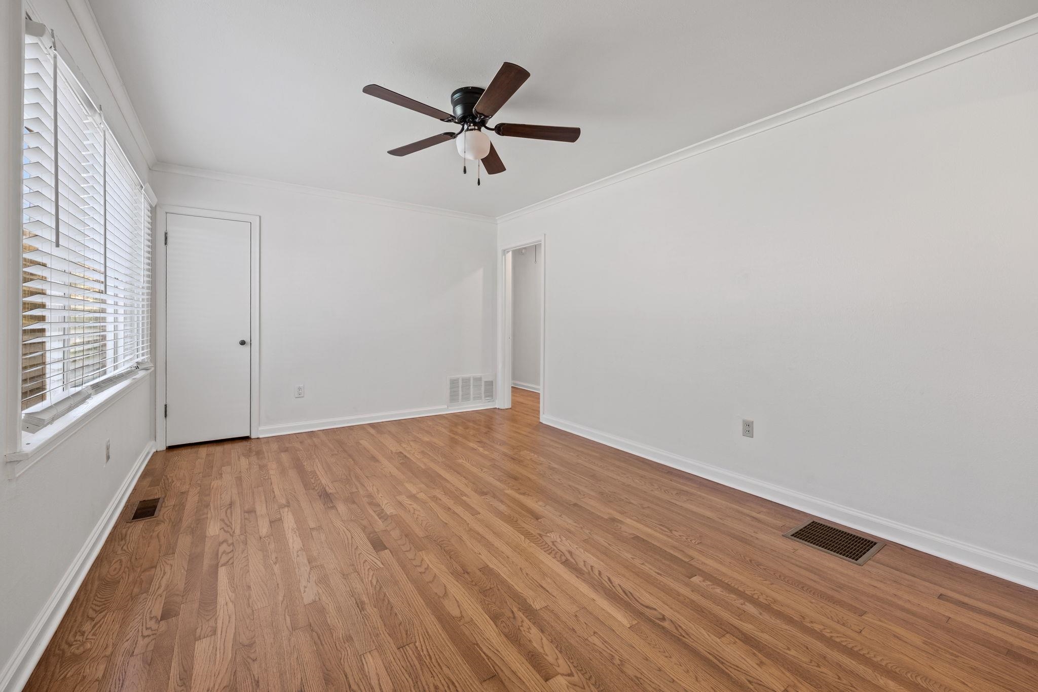 1261 Marcia Road Memphis, TN 38117 - Photo 6 of 27 a view of empty room with wooden floor and fan