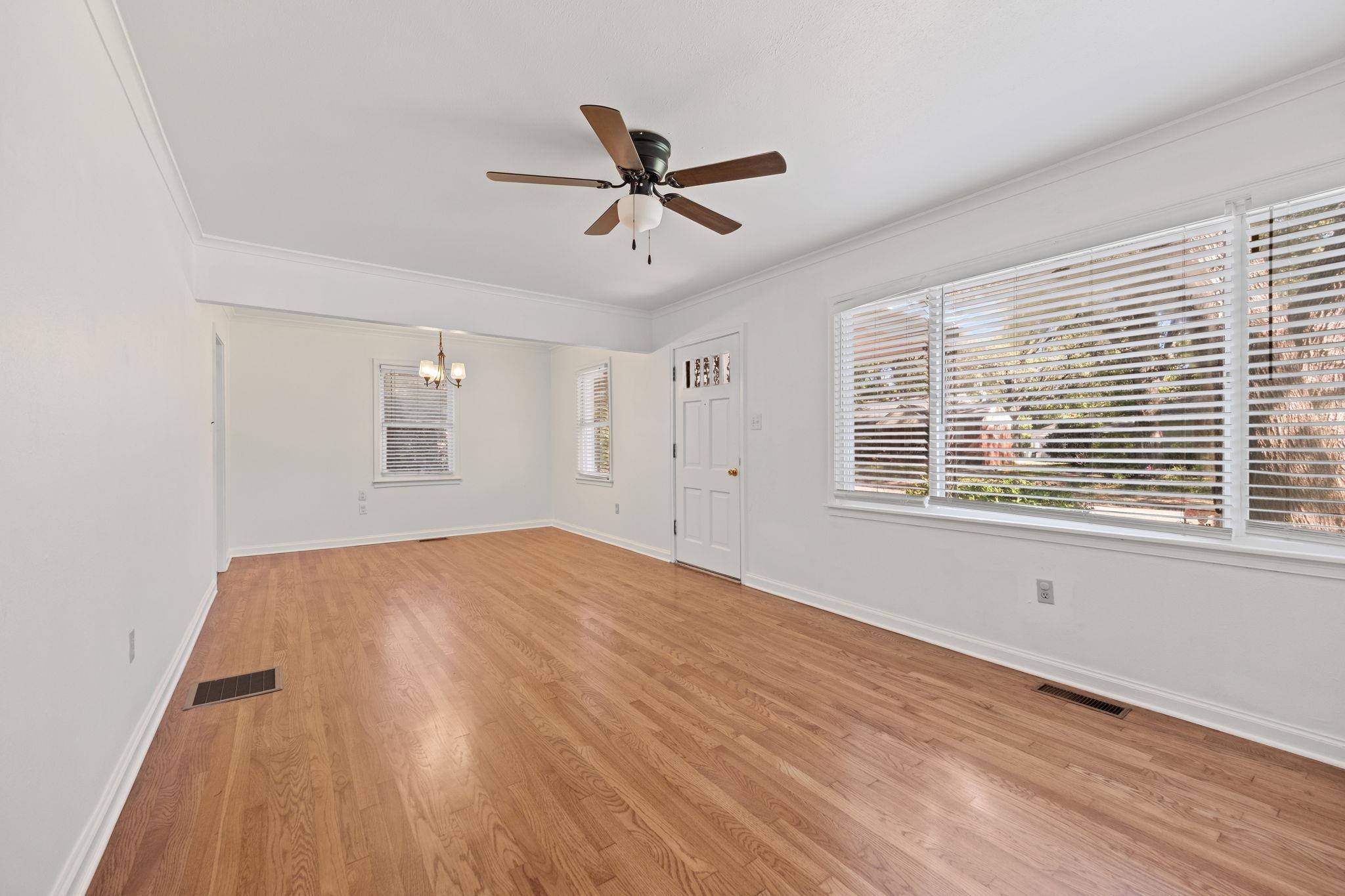 1261 Marcia Road Memphis, TN 38117 - Photo 7 of 27 a view of empty room with wooden floor and fan
