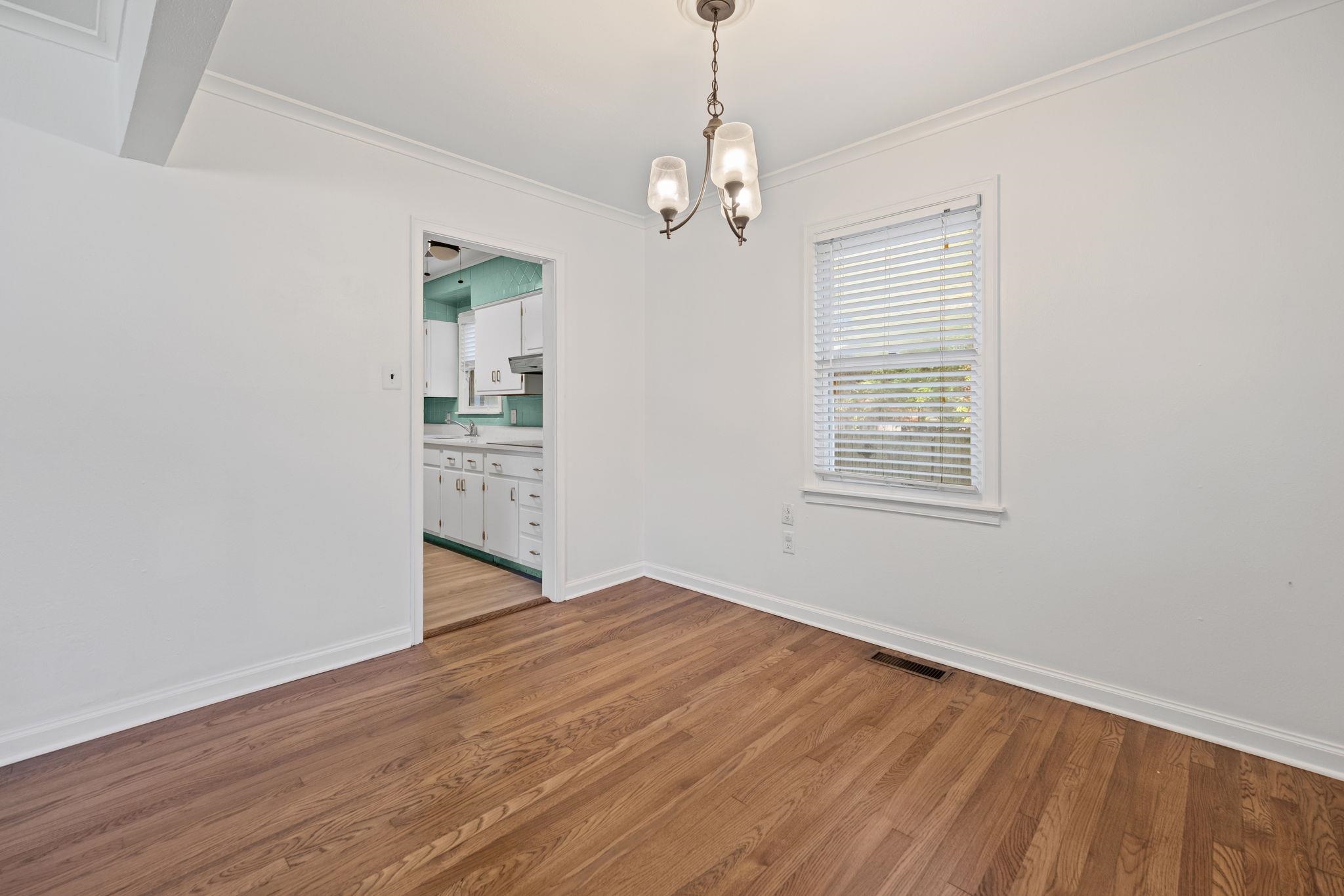 1261 Marcia Road Memphis, TN 38117 - Photo 9 of 27 a view of an empty room with wooden floor and a window