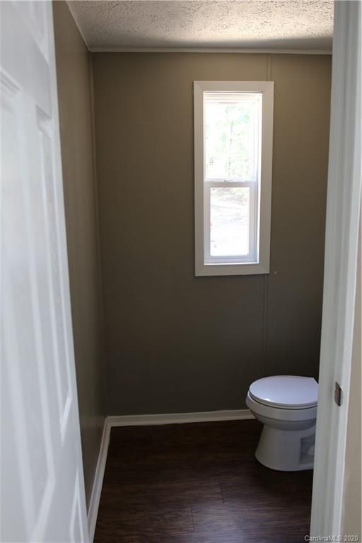 6710 Santa Claus Road Monroe, NC 28110 - Photo 14 of 30 a bathroom with a toilet and a window
